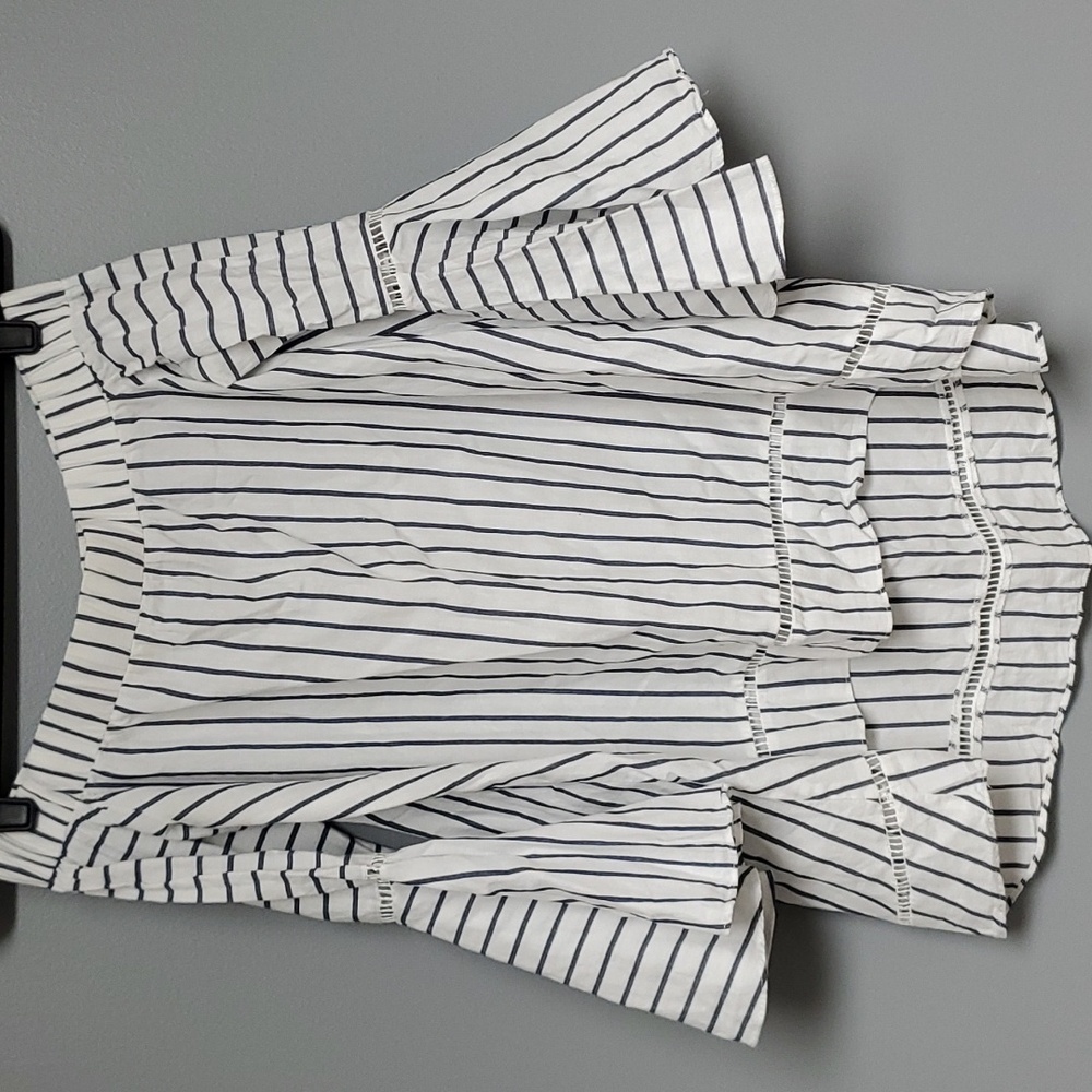 Striped blue and white shirt with wide detailed sleeves.